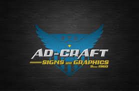 Ad-Craft Signs and Graphics logo, featuring a blue eagle with a bold, metallic finish. The text "AD-CRAFT" is prominently displayed, and "SIGNS and GRAPHICS" is included in a smaller font. The logo is set against a dark, wood-grain background.